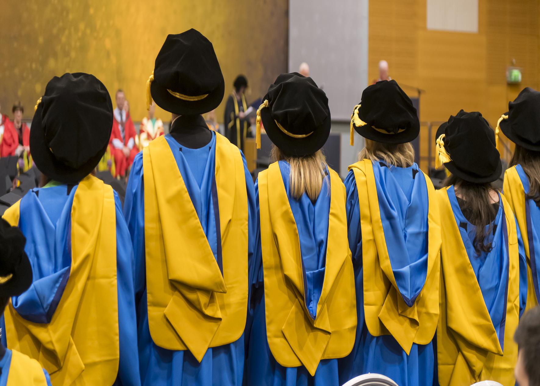 Students standing at graduation ceremony